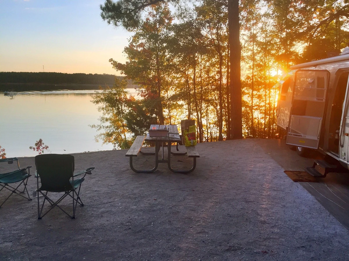 A peaceful lakeside campsite at sunset